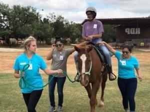 Patty Hanks students practice leading a horse. 